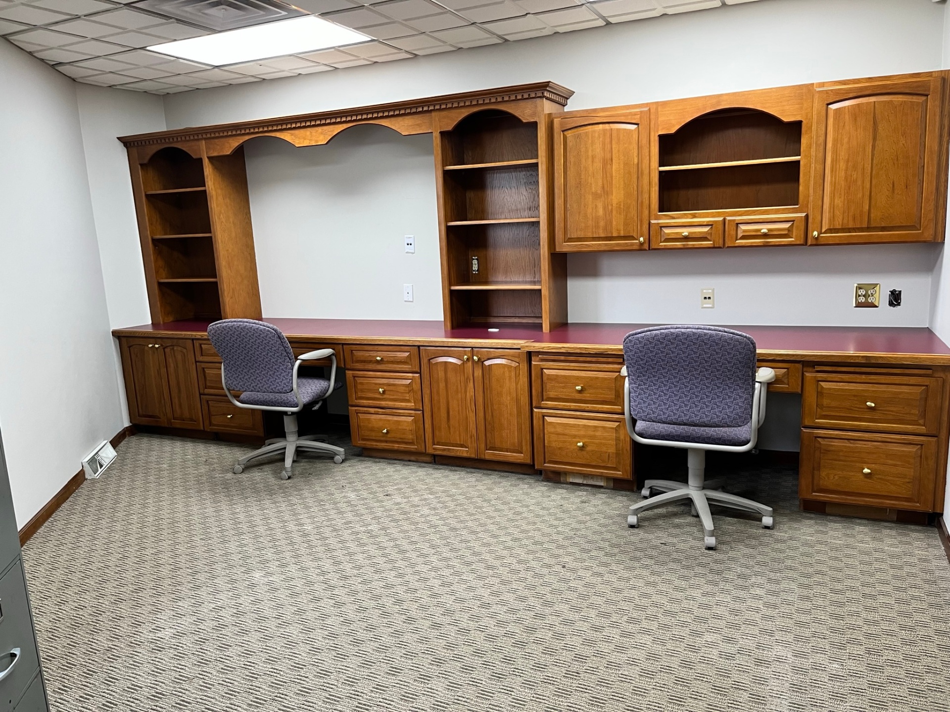 Clean office workspace with built-in cabinetry and desks